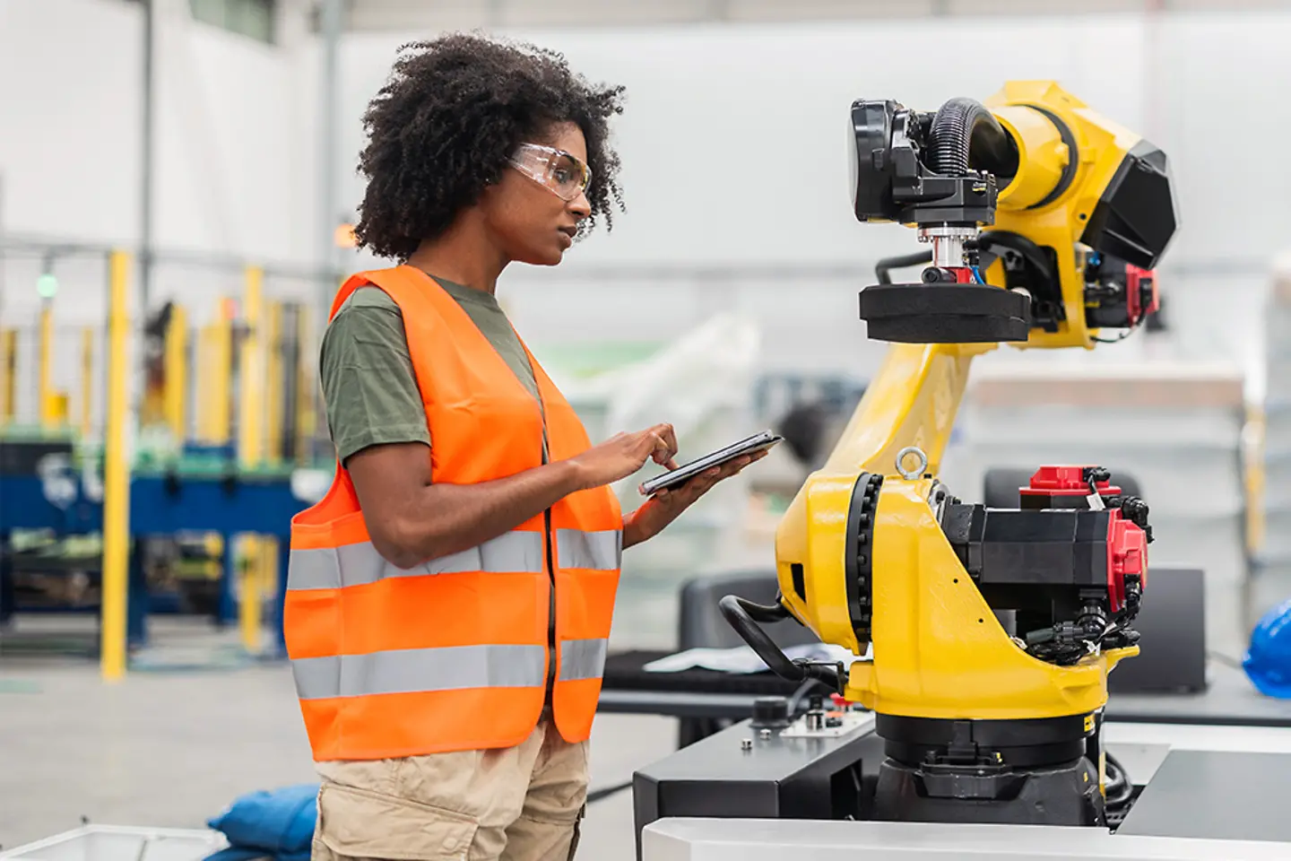 Female engineer programming factory robot