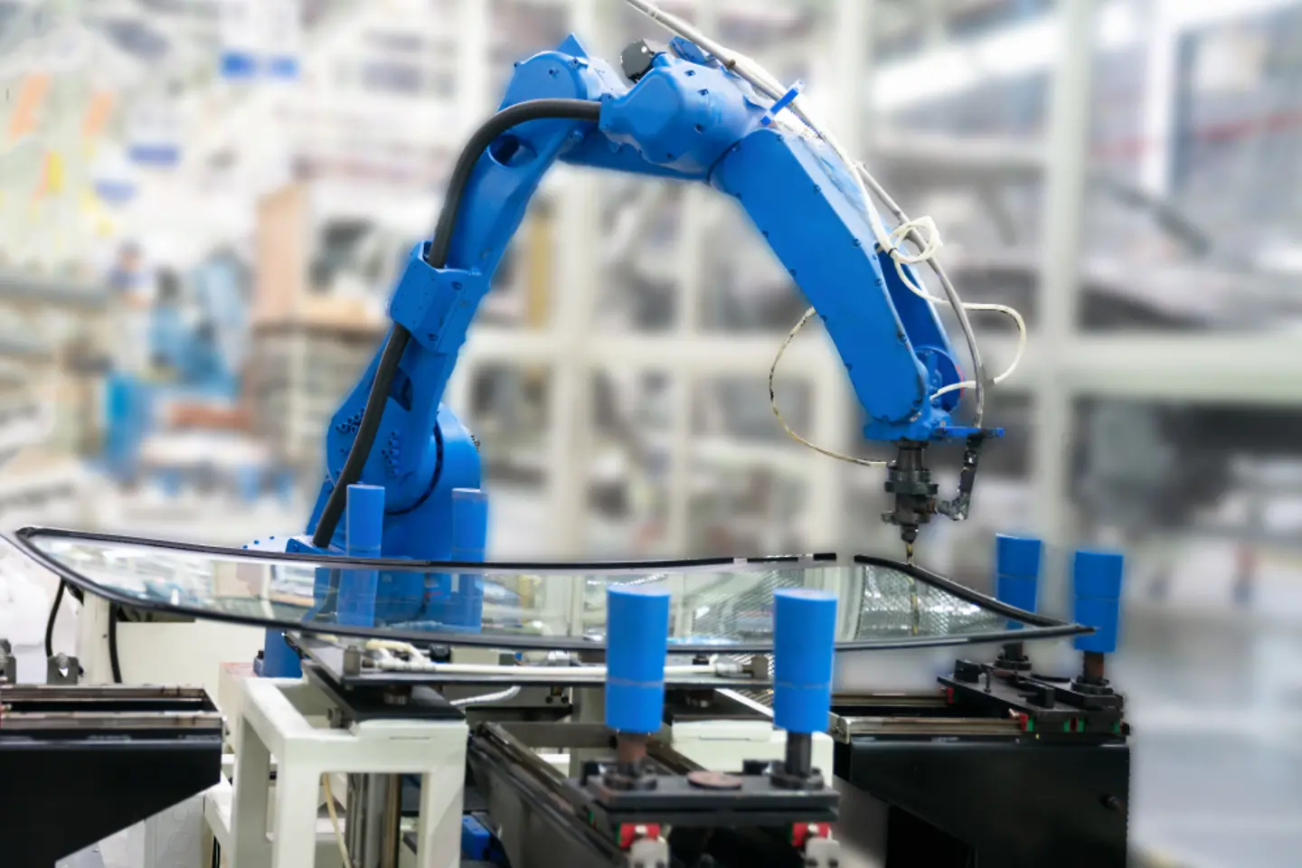 Blue robot in factory hall.